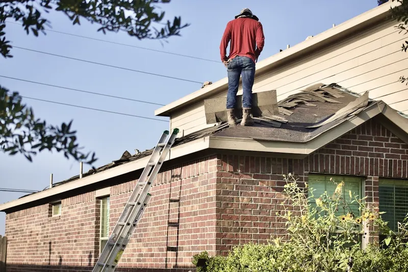Professional roofer working on a residential roof in Denham Springs